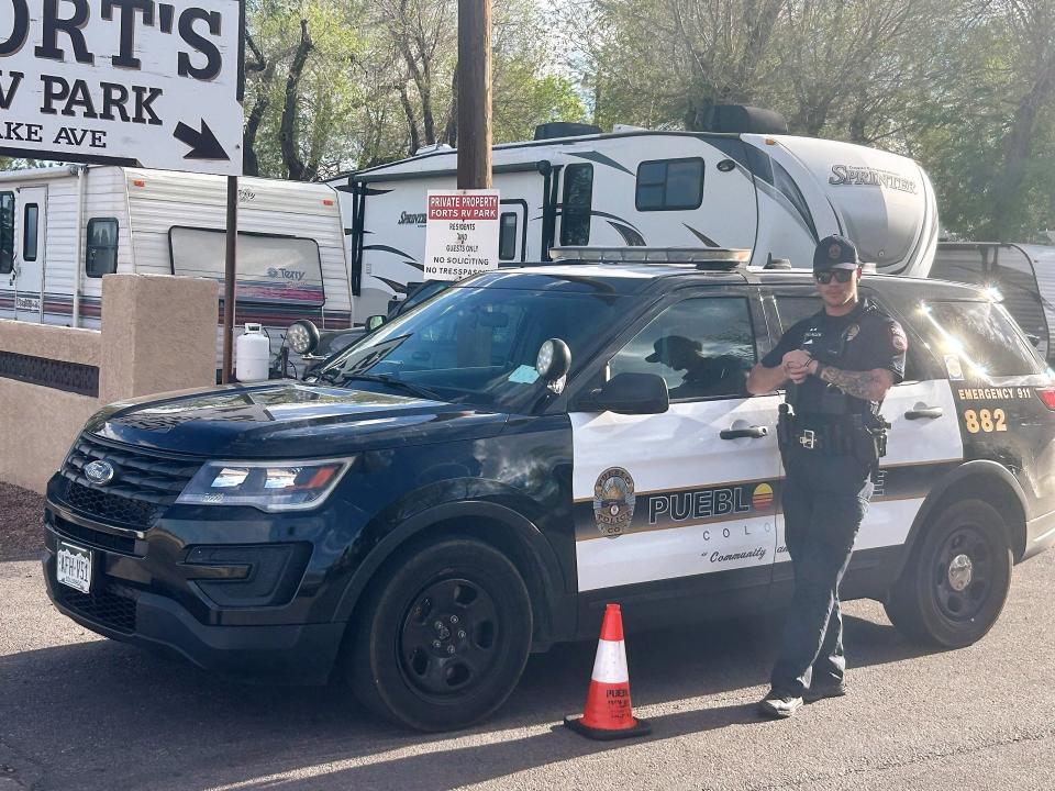 A Pueblo police officer stands near a police SUV at Fort's RV Park on Lake Avenue while police investigate a shooting involving police officers on April 17, 2024.