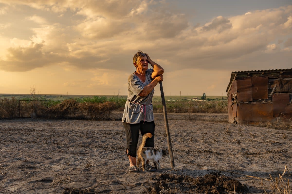 Olha stands on her land destroyed by the flood from the exploded dam in Kherson (Bel Trew)