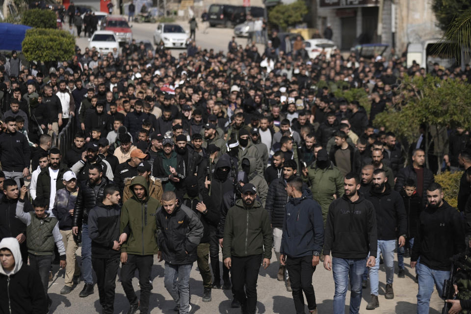 Palestinian gunmen and mourners march ahead of Mohammed Daraghmeh, 26, and Muhammad Bayadsa 32, and Osama Zalat 31, during their funeral in the West Bank town of Tubas, Tuesday, Feb. 27, 2024. Israeli troops shot and killed three Palestinian men including Daraghmeh, a co-founder of the local branch of Islamic Jihad in the northern town of Tubas, early Tuesday, Palestinian health authorities said. Thee was no immediate comment from the Israeli military. (AP Photo/Majdi Mohammed)
