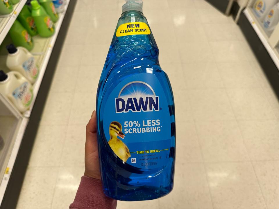 hand holding up a big bottle of dawn dish soap at target