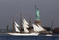 The Cisne Branco, from Brazil, sails by the Statue Of Liberty, in New York, to participate in Fleet Week activities, Wednesday, May 23, 2012. This year's event marks the bicentennial of the War of 1812. (AP Photo/Richard Drew)