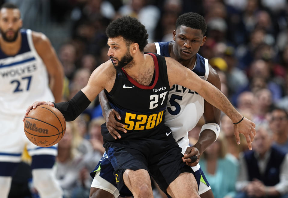 Denver Nuggets guard Jamal Murray, front, looks to drive to the basket as Minnesota Timberwolves guard Anthony Edwards defends during the second half of Game 5 of an NBA basketball second-round playoff series Tuesday, May 14, 2024, in Denver (AP Photo/David Zalubowski)