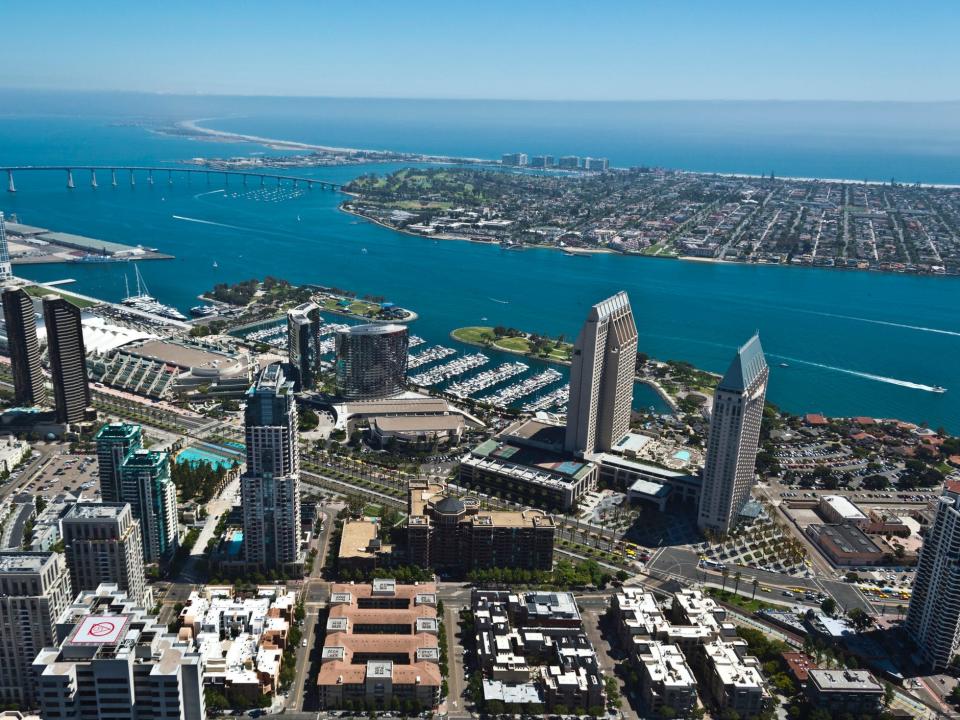 An aerial of the San Diego Convention Center with San Diego Harbor.