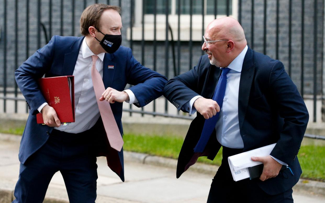 Matt Hancock and Nadhim Zahawi elbow-bump a greeting to one another on Downing Street in London - David Cliff/NurPhoto