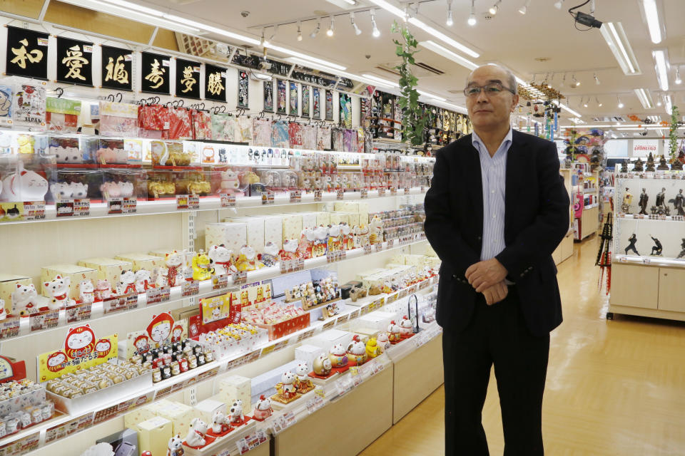 Akky International Corp. Chief Executive Hideyuki Abe looks around his store in the Akihbara electronics district of Tokyo on Oct. 3, 2022. Individual travelers will be able to visit Japan without visas beginning Tuesday, Oct. 11, just like in pre-COVID-19 times. (AP Photo/Yuri Kageyama)