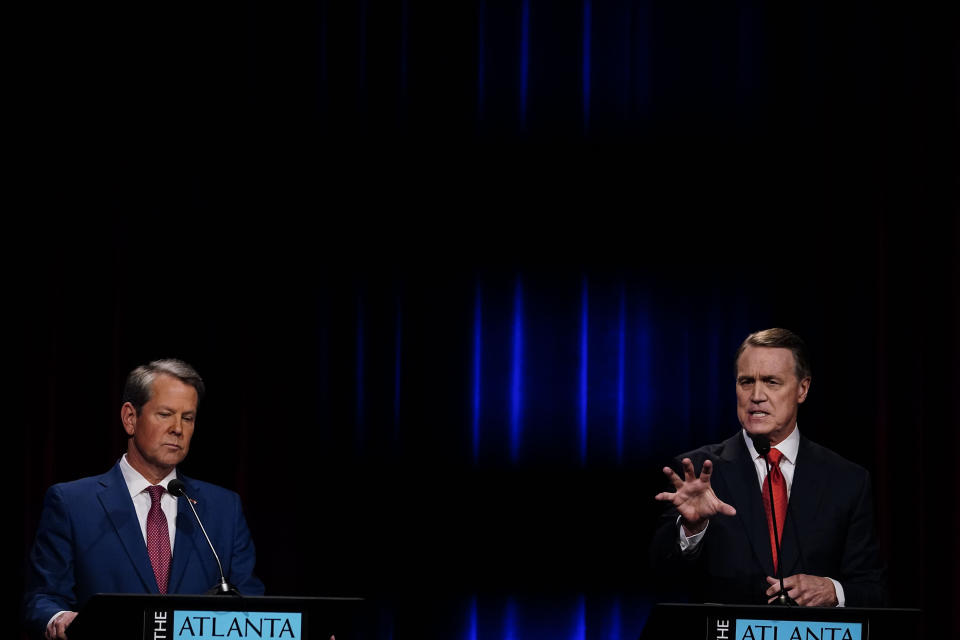 Former Sen. David Perdue, right, speaks during a gubernatorial Republican primary debate toward Georgia Gov. Brian Kemp, left, Sunday, May 1, 2022, in Atlanta. (AP Photo/Brynn Anderson, Pool)