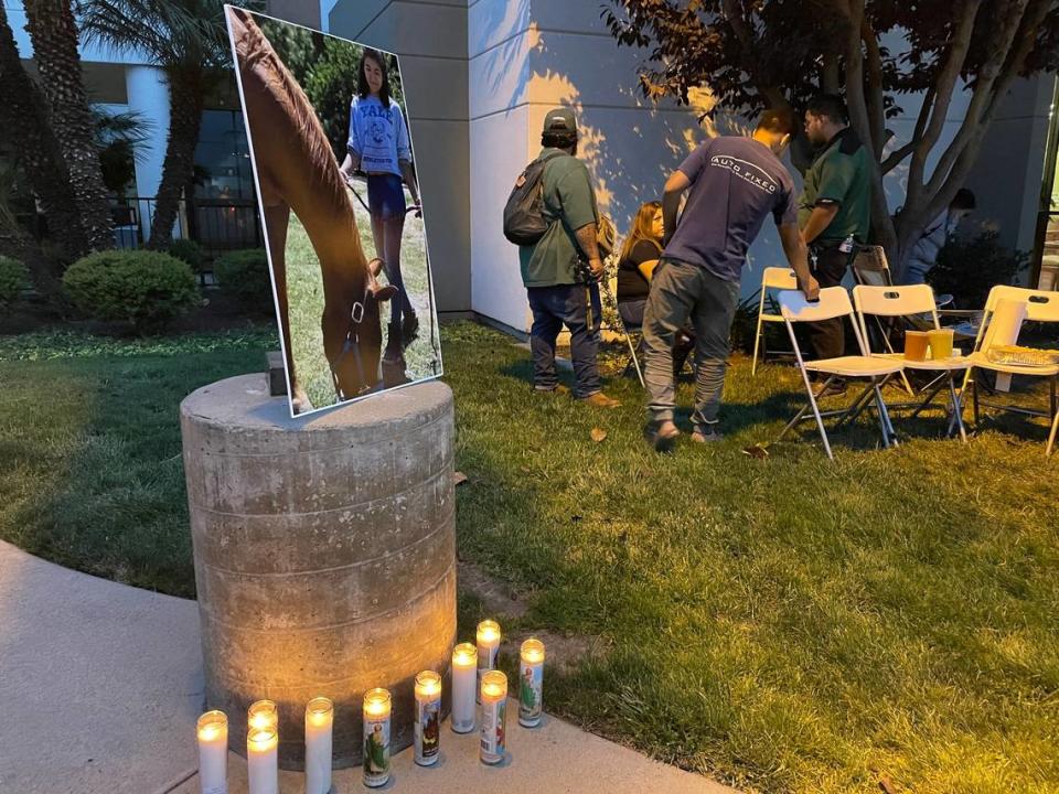A photo of Summer Vigil-Gardner and her horse Riggs looms over candles during a prayer gathering on Aug. 13, 2021, at Doctors Medical Center. A distracted driver hit the two, killing Riggs and leaving Summer in critical condition.