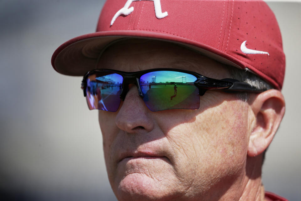 TD Ameritrade Park, home of the College World Series, is reflected in the sunglasses of Arkansas NCAA college baseball coach Dave Van Horn during team practice in Omaha, Neb., Friday, June 14, 2019. Arkansas opens College World Series play Saturday night against Florida State, which will be trying to win retiring coach and NCAA all-time wins leader Mike Martin's first national championship in his 17 visits to Omaha. (AP Photo/Nati Harnik)