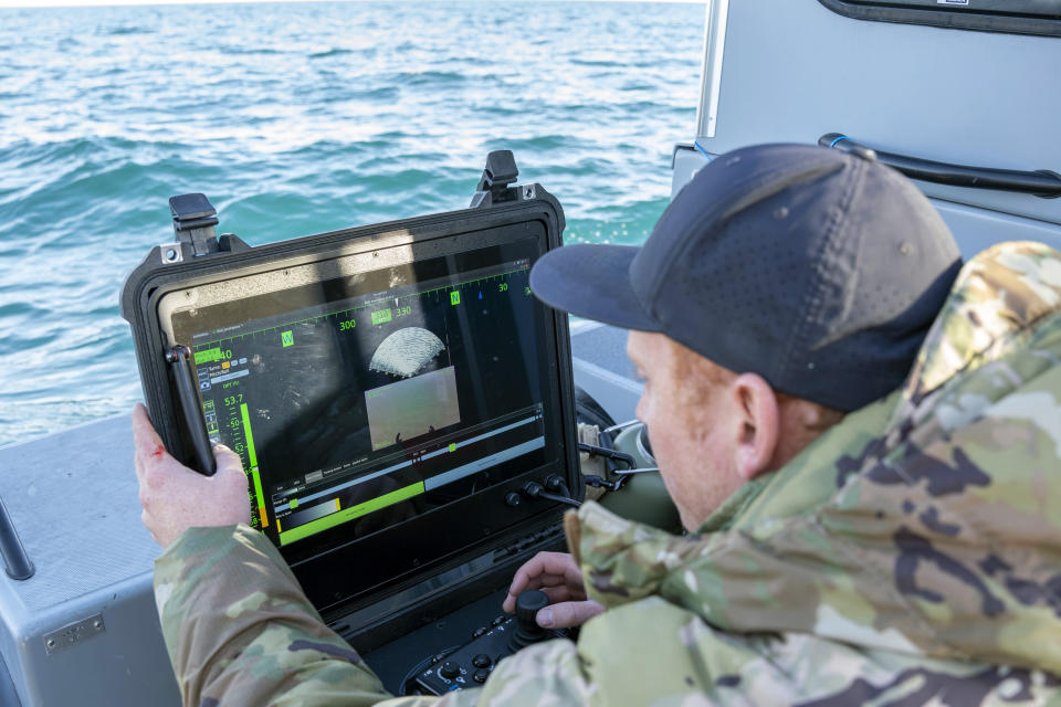 FILE - In this image provided by the U.S. Navy, a sailor assigned to Explosive Ordnance Disposal Group 2 conducts a search for debris with an underwater vehicle during recovery efforts of a Chinese high-altitude balloon in the Atlantic Ocean, off the coast of Myrtle Beach, S.C., Feb. 7, 2023. (Ryan Seelbach/U.S. Navy via AP, File)