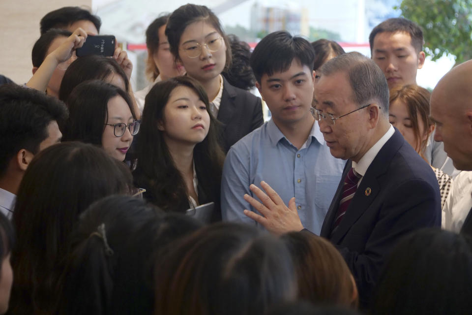 Former U.N. Secretary-General Ban Ki-moon, fourth right, speaks with attendees on the sidelines of a press conference for the release of a report on adapting to climate change in Beijing, Tuesday, Sept. 10, 2019. A group of leaders from business, politics and science called Monday for a massive investment in adapting to climate change over the next decade, arguing it would reap significant returns as countries avoid catastrophic losses and boost their economies. (AP Photo/Sam McNeil)