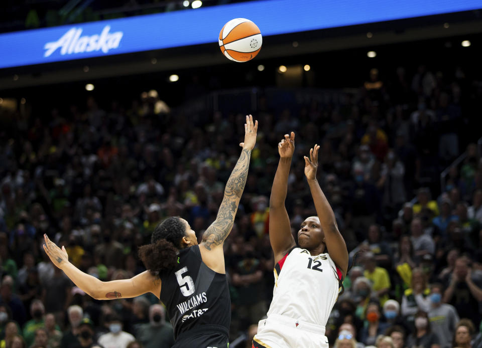 Las Vegas Aces guard Chelsea Gray (12) shoots over Seattle Storm forward Gabby Williams (5) during the first half in Game 3 of a WNBA basketball semifinal playoff series Sunday, Sept. 4, 2022, in Seattle. (AP Photo/Lindsey Wasson)