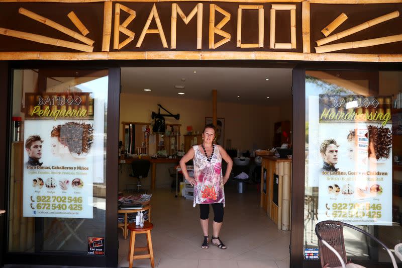 FILE PHOTO: Veness poses at the entrance of her empty hair saloon located in front of the H10 Costa Adeje Palace hotel, which has been under lockdown over a coronavirus outbreak in Adeje