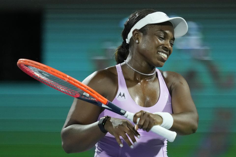 Sloane Stephens of the U.S. reacts after losing a ball to Iga Swiatek of Poland during a match of the Dubai Duty Free Tennis Championships in Dubai, United Arab Emirates, Monday, Feb. 19, 2024. (AP Photo/Kamran Jebreili)