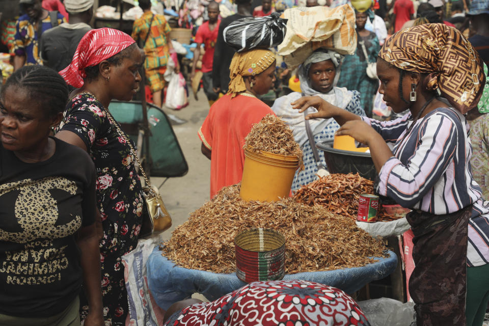 A woman sells crayfish at a Mile 12 Market in Lagos, Nigeria, Friday, Feb. 16, 2024. Nigerians are facing one of the West African nation's worst economic crises in as many years triggered by a surging inflation rate which follows monetary policies that have dipped the local currency to an all-time low against the dollar, provoking anger and protests across the country. (AP Photo/Mansur Ibrahim)
