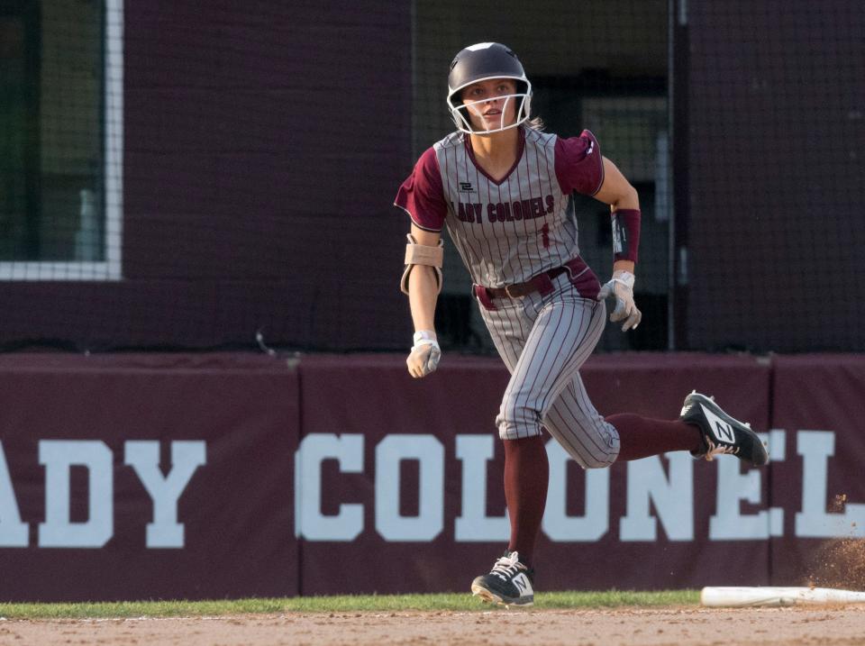 Henderson County’s Kaytlan Kemp (1) eyes her fly ball while running to first as the Henderson County Lady Colonels play the Union County Lady Braves in Henderson, Ky., Wednesday evening, May 19, 2021.