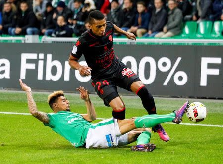 Football Soccer - St. Etienne v Nice - French Ligue 1 - Geoffroy Guichard stadium, Saint-Etienne, France - 20/11/2016. St. Etienne's Kevin Malcuit (bottom) in action against Nice's Henrique Dalbert (top). REUTERS/Robert Pratta