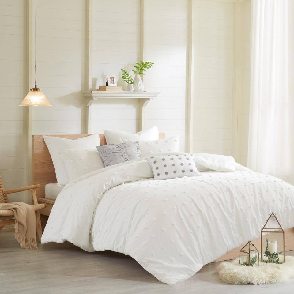 White fluffy bedding set on the bed