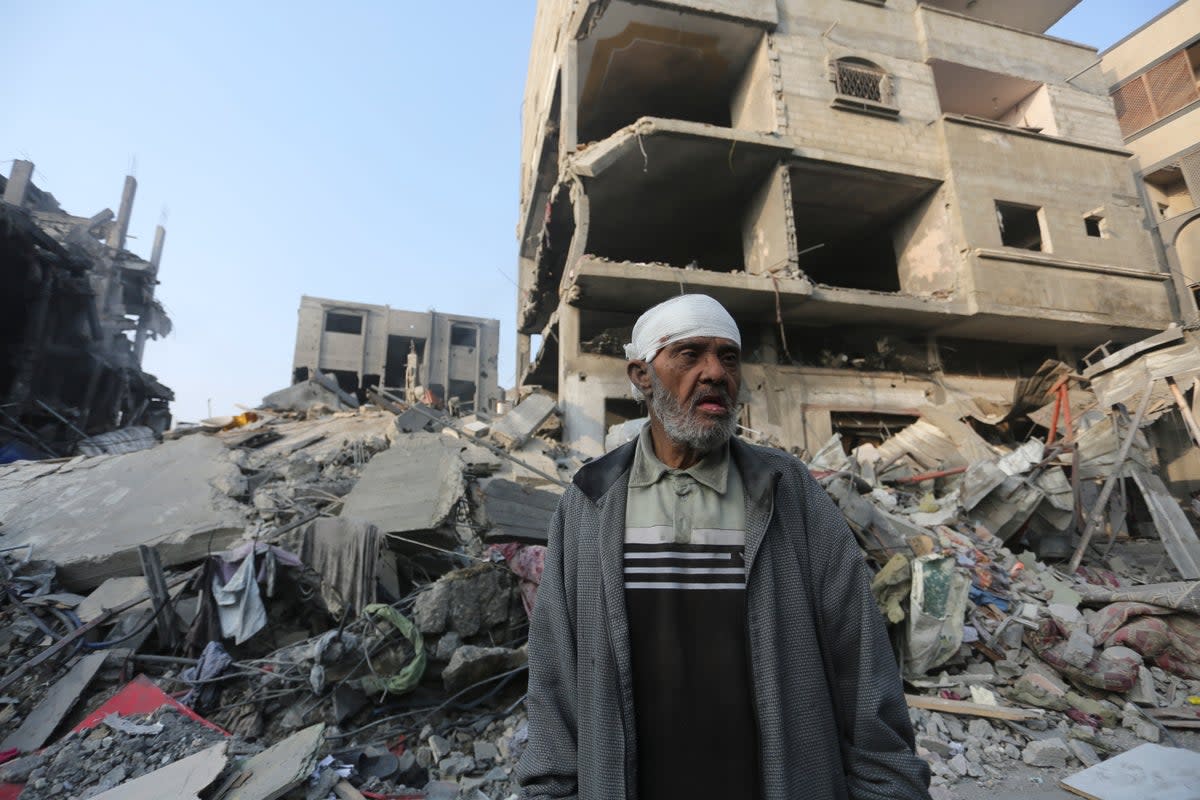 A Palestinian stands outside the building destroyed i the Israeli bombardment of the Gaza Strip in Rafah (Copyright 2023 The Associated Press. All rights reserved.)