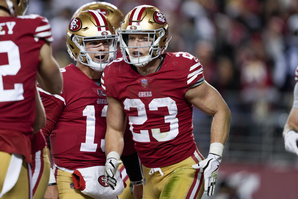 San Francisco 49ers running back Christian McCaffrey (23) celebrates after scoring a touchdown with quarterback Brock Purdy during the second half of an NFL divisional round playoff football game against the Dallas Cowboys in Santa Clara, Calif., Sunday, Jan. 22, 2023. (AP Photo/Tony Avelar)