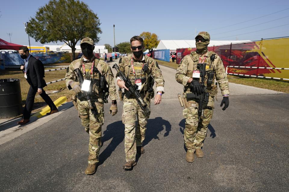 Security personnel arrive before the NFL Super Bowl 55 football game between the Kansas City Chiefs and Tampa Bay Buccaneers, Sunday, Feb. 7, 2021, in Tampa, Fla. (AP Photo/Mark Humphrey)