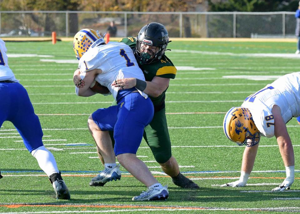 DelVal senior linebacker Nick Chapman makes the tackle on Widener running back Bryce Casey.