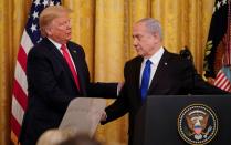 U.S. President Trump and Israel's Prime Minister Netanyahu shake hands announcing Middle East peace proposal at news conference at White House in Washington