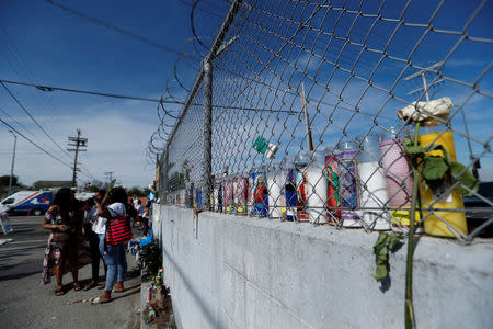 Candles and flowers are seen by the clothing store of Grammy-nominated rapper Nipsey Hussle who was shot and killed in Los Angeles, California, U.S., April 1, 2019. REUTERS/Mario Anzuoni