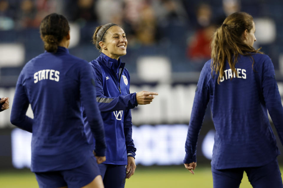 United States' Carli Lloyd, center, reacts as she warms up with teammates before an international friendly soccer match against South Korea in Kansas City, Kan., Thursday, Oct. 21, 2021. (AP Photo/Colin E. Braley)