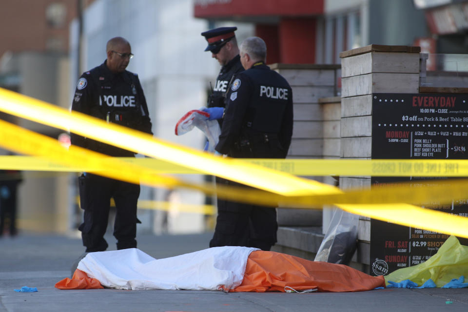 Toronto police, covered body after van incident