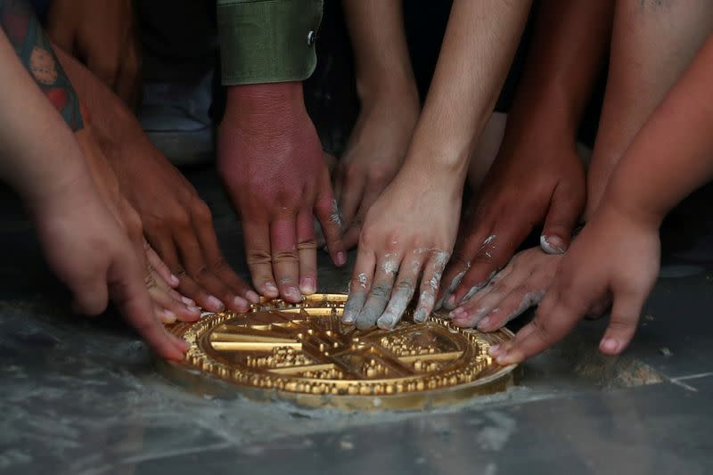 Student leaders install a plaque near the Grand Palace in Bangkok