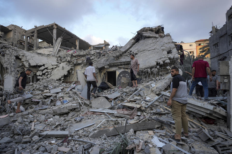 Palestinians look at the destruction after an Israeli airstrike in Deir al Balah, Gaza Strip, Tuesday, April 30, 2024. (AP Photo/Abdel Kareem Hana)