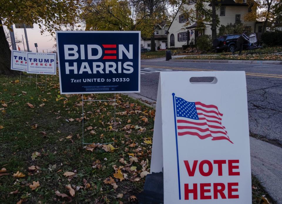 Trump and Pence signs and Biden, Harris signs are seen near Eisenhower Elementary School a polling area in Flint, Michigan on November 3, 2020. - The US is voting Tuesday in an election amounting to a referendum on Donald Trump's uniquely brash and bruising presidency, which Democratic opponent and frontrunner Joe Biden urged Americans to end to restore "our democracy." (Photo by Seth Herald / AFP) (Photo by SETH HERALD/AFP via Getty Images)