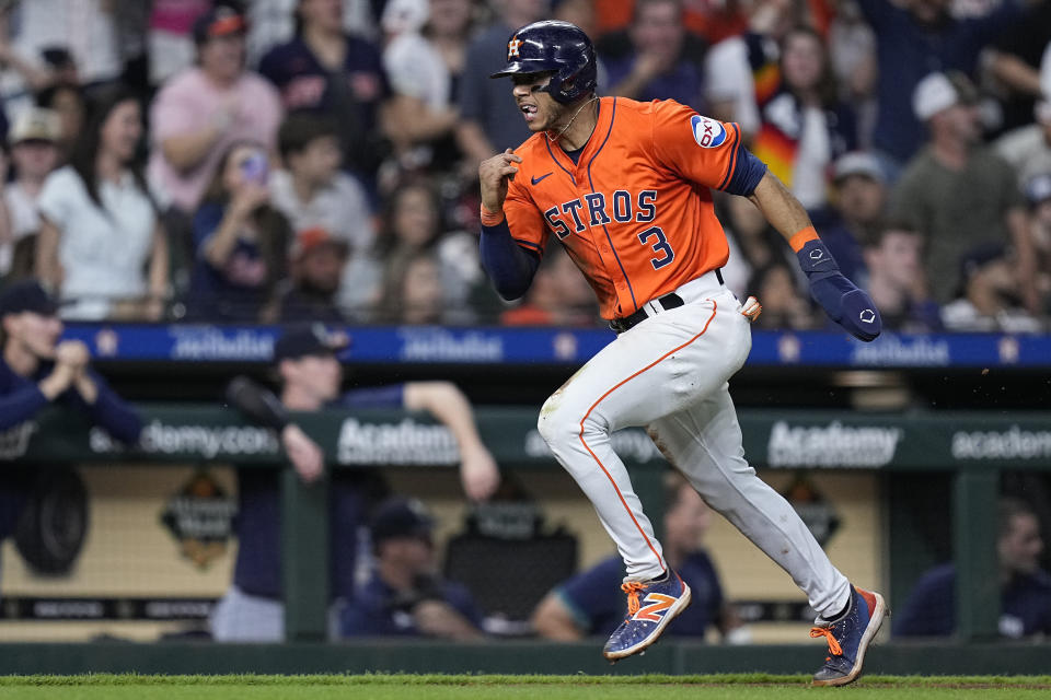 Houston Astros' Jeremy Peña runs to score on a throwing error by Seattle Mariners catcher Cal Raleigh during the seventh inning of a baseball game Friday, May 3, 2024, in Houston. (AP Photo/Kevin M. Cox)
