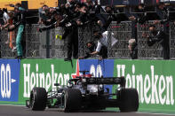 Mercedes driver Lewis Hamilton of Britain crosses the finish line to win the Portugal Formula One Grand Prix at the Algarve International Circuit near Portimao, Portugal, Sunday, May 2, 2021. (AP Photo/Manu Fernandez)