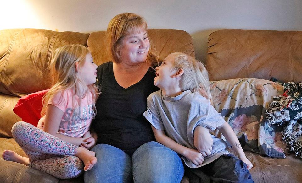 Mom Christina Olson with two of her three children, Faith, 7, and Wyatt, 5, in their Quincy home.