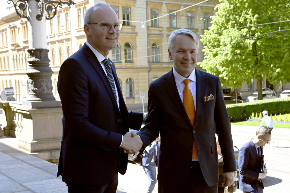 Irish Foreign Minister Simon Coveney, left, and Finnish Foreign Minister Pekka Haavisto meet at the House of Estates in Helsinki, Finland, Tuesday, June 7, 2022. (Antti Aimo-Koivisto/Lehtikuva via AP)