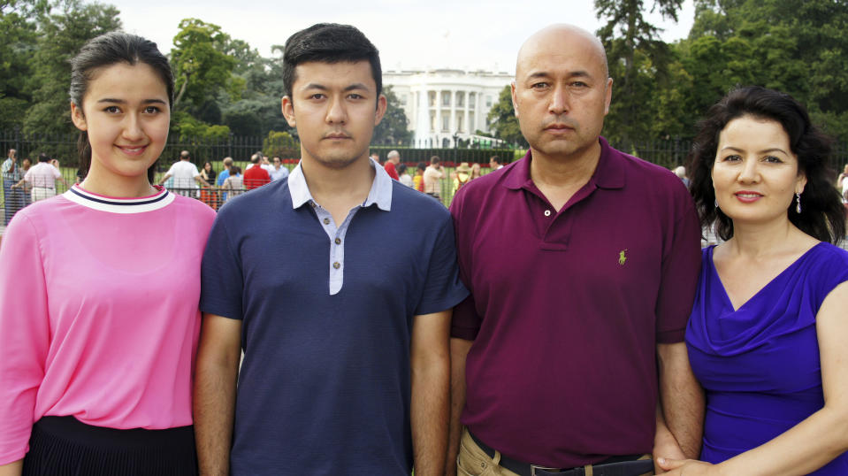 In this Aug. 11, 2014, photo provided by the his family, Yalqun Rozi, second right, stands with his family during trip to Washington. From left are his daughter, Tumaris Yalqun; son, Kamalturk Yalqun and his wife, Zaynap Ablajan. Yalqun's family lives in exile in Philadelphia. (AP Photo/Yalqun Family)