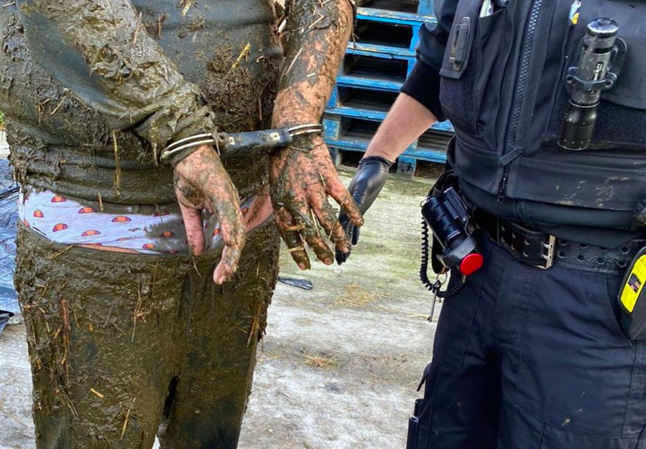 The suspect was covered in poo from jumping into a slurry pit as he was arrested. (Sussex Police)