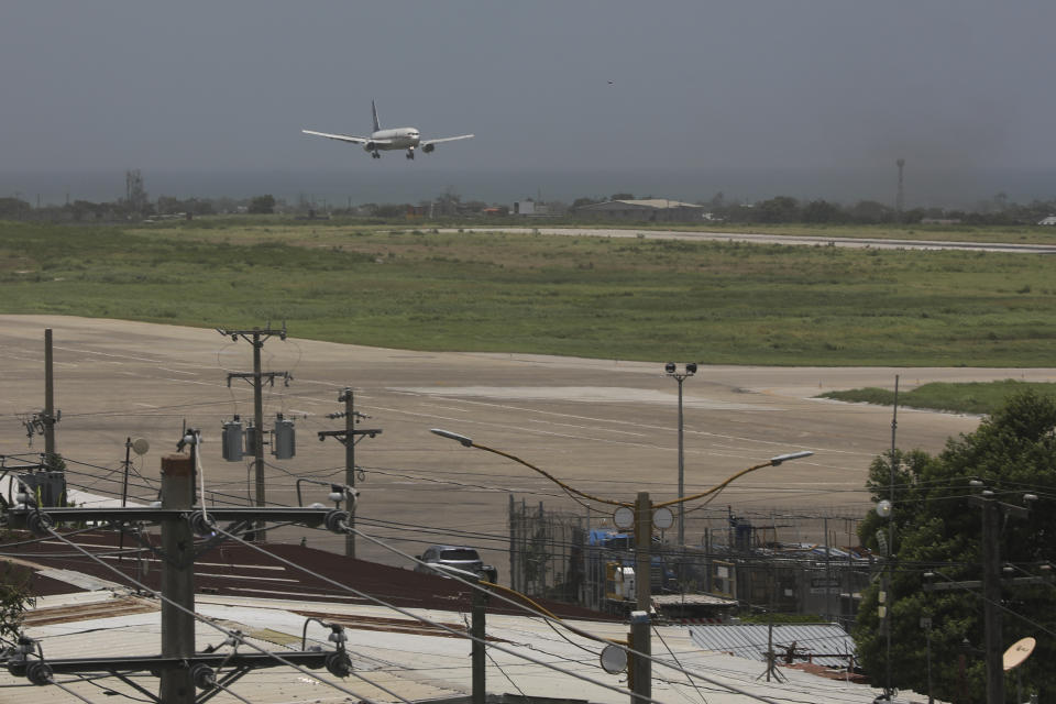 An Amerijet plane prepares to land as it arrives at the Toussaint Louverture International Airport in Port-au-Prince, Haiti, Monday, May 20, 2024. Haiti's main international airport reopened Monday for the first time in nearly three months after gang violence forced authorities to close it in early March. (AP Photo/Odelyn Joseph)