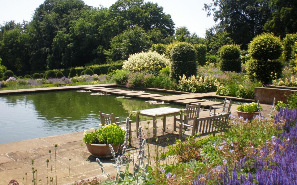 Visitors to Broughton Grange can happily waste a day walking though flower borders and along the pond walls in summer - National Garden Scheme