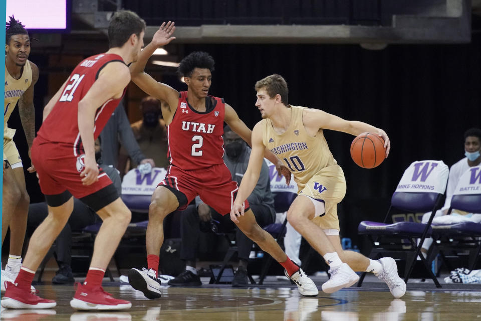 Washington guard Erik Stevenson drives past Utah guard Ian Martinez (2) during the second half of an NCAA college basketball game, Sunday, Jan. 24, 2021, in Seattle. Washington won 83-79. (AP Photo/Ted S. Warren)