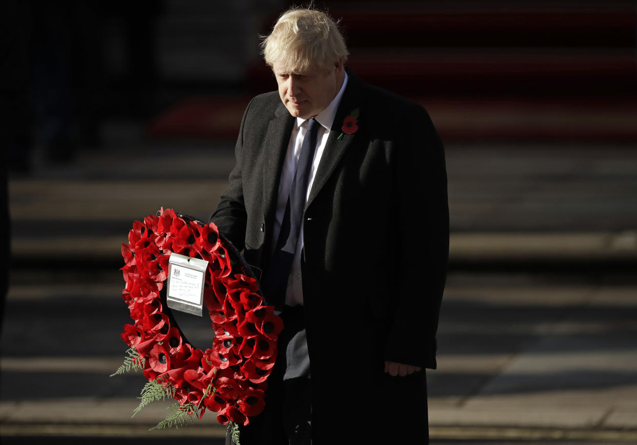 British Prime Minister Boris Johnson prepares to lay a wreath during the Remembrance Sunday ceremony at the Cenotaph in Whitehall in London, Sunday, Nov. 10, 2019. Remembrance Sunday is held each year to commemorate the service men and women who fought in past military conflicts. (AP Photo/Matt Dunham)