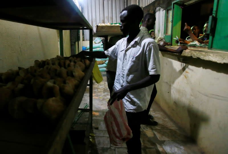 Workers arrange bread for sale at a bakery in Khartoum