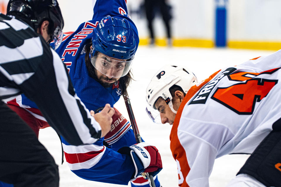 New York Rangers' Mika Zibanejad (93) and Philadelphia Flyers' Morgan Frost, wait for the puck drop on a faceoff during the second period of an NHL hockey game Tuesday, March 26, 2024 in New York. (AP Photo/Peter K. Afriyie)