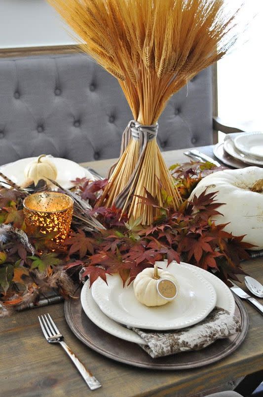 <p>When it comes to Thanksgiving decor, wheat stalks are a popular choice. Take yours to the next level by setting them on a pile of leaves straight from your yard. Add pumpkins and tea lights for more visual interest.<br></p><p><em><a href="http://dearlillieblog.blogspot.com/2014/11/a-simple-thanksgiving-table-setting.html" rel="nofollow noopener" target="_blank" data-ylk="slk:Get the tutorial at Dear Lillie »;elm:context_link;itc:0;sec:content-canvas" class="link ">Get the tutorial at Dear Lillie »</a></em></p>