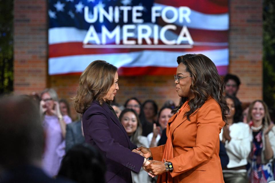 US Vice President and Democratic presidential candidate Kamala Harris (L) joins US television producer Oprah Winfrey at a 'Unite for America' live streaming rally in Farmington Hills, Michigan, on September 19, 2024 (AFP via Getty Images)