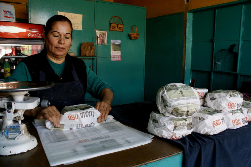 Esperanza Lozoya wraps tortillas packaged with advertisements that ask for help to find missing women and children, at the Hermanos Escobar Tortilla shop in the northern border city of Ciudad Juarez, Mexico, Tuesday Nov. 13, 2012. At least three dozen tortilla shops have joined in the Chihuahua state campaign to print appeals for help on thin paper wrappers that shopkeepers use to wrap up a pound or two of hot tortillas at a time. (AP Photo/Raymundo Ruiz)