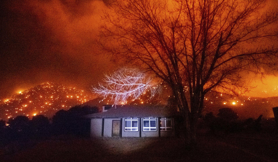 Embers from the Mountain View Fire burn along hillsides in the Walker community of Mono County, Calif., on Tuesday, Nov. 17, 2020. (AP Photo/Noah Berger)