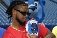 Buffalo Bills defensive back Damar Hamlin poses with a AED (Automatic Electronic Defibrillator) to help resuscitate heart attack victims, to local community groups following the announcement of the first program of his Chasing M's Foundation, the Chasing M's Foundation CPR Tour, Saturday, June 3, 2023, in Orchard Park, N.Y. (AP Photo/Jeffrey T. Barnes)