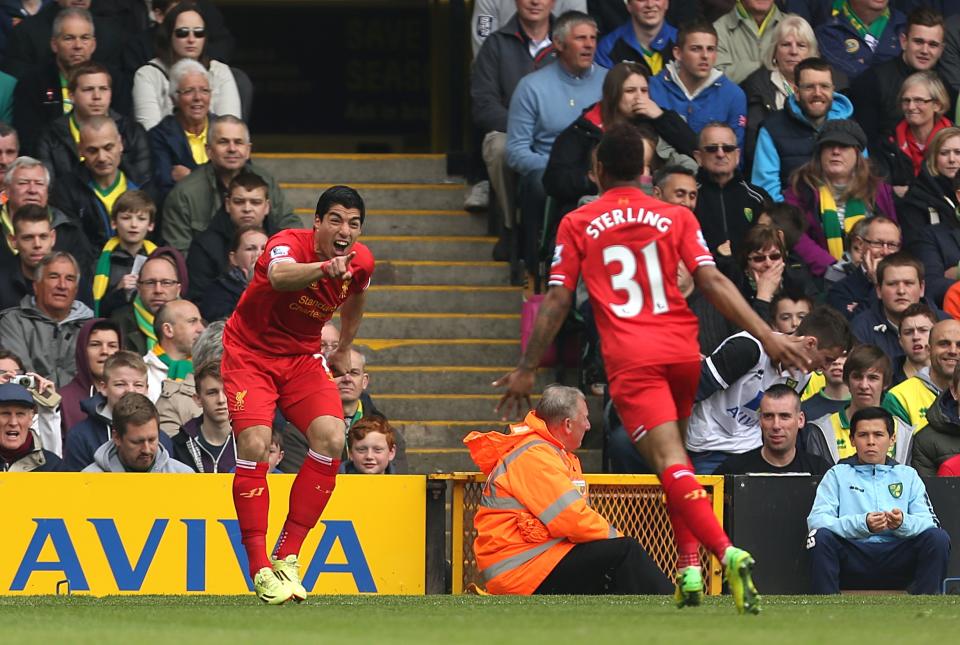 Liverpool's Luis Suarez, left, celebrates scoring his side's second goal with Raheem Sterling who scored their first, during their English Premier League match against Norwich City at Carrow Road, Norwich, eastern England, Sunday April 20, 2014. (AP Photo/PA, Chris Radburn) UNITED KINGDOM OUT NO SALES NO ARCHIVE